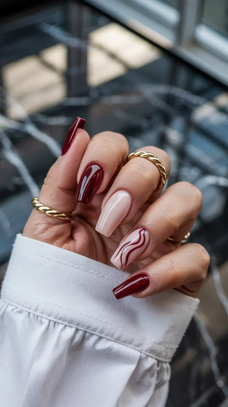 fall winter nails 2025 burgundy swirl design