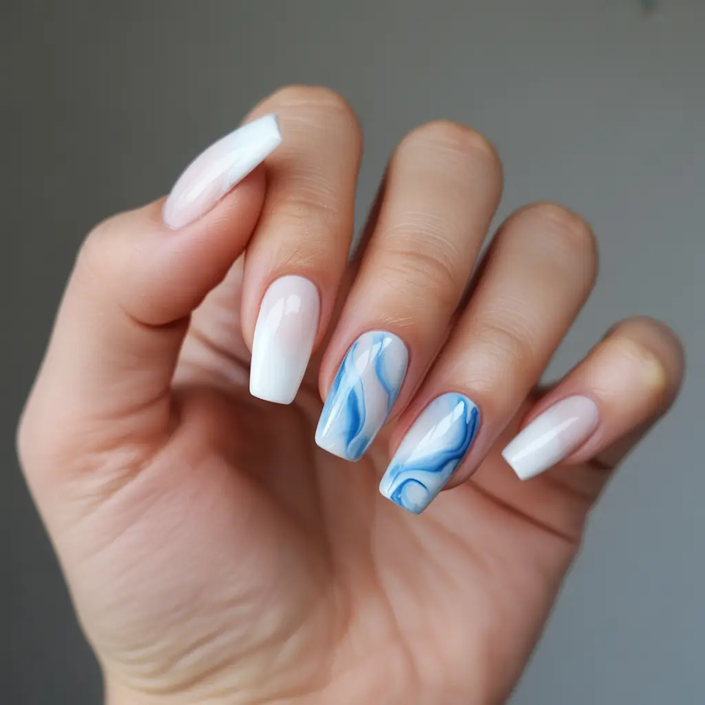 cute spring nails ideas 2026 Soft Blue Water Marble With White Accents