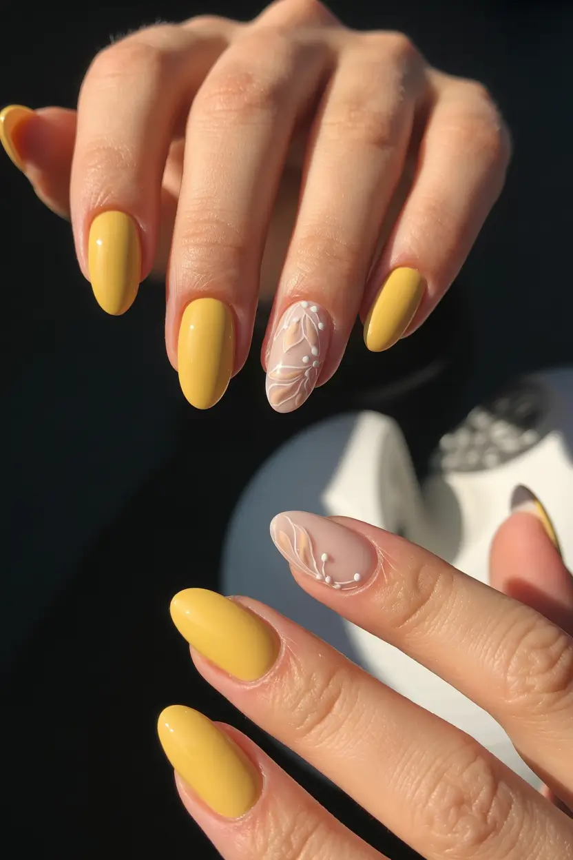 feminine classy spring nails 2026 Sunny Yellow Almond With Soft Botanical Accent