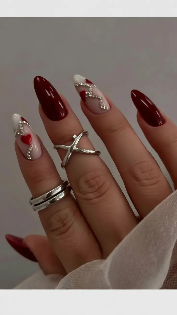 March Nails - Spring Ideas 2026 Deep Red Accents With Crystal Heart Details