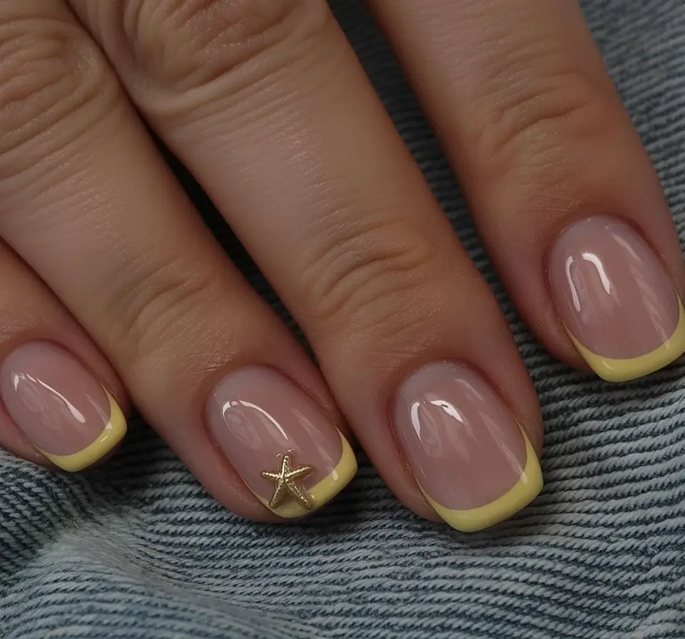 sophisticated spring french tip nails 2026 Butter Yellow Micro French with Gold Accent